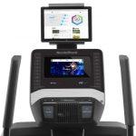 Console screen of the Nordictrack FS7i elliptical with an image of weekly health results.The elliptical features a fan, several buttons, 1 cup holder, a speaker and a tablet holder