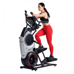 A fit woman in athletic attire working out on the Bowflex Trainer M6