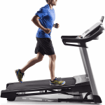 A fit man in athletic attire running on the C 700 treadmill
