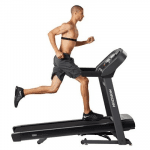 A fit man in athletic attire running on the Horizon T202 Treadmill