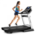 A woman in athletic attire runnig on the Smart Pro 5000 Treadmill