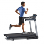A man in athletic attire running on the LifeSpan TR4000i treadmill